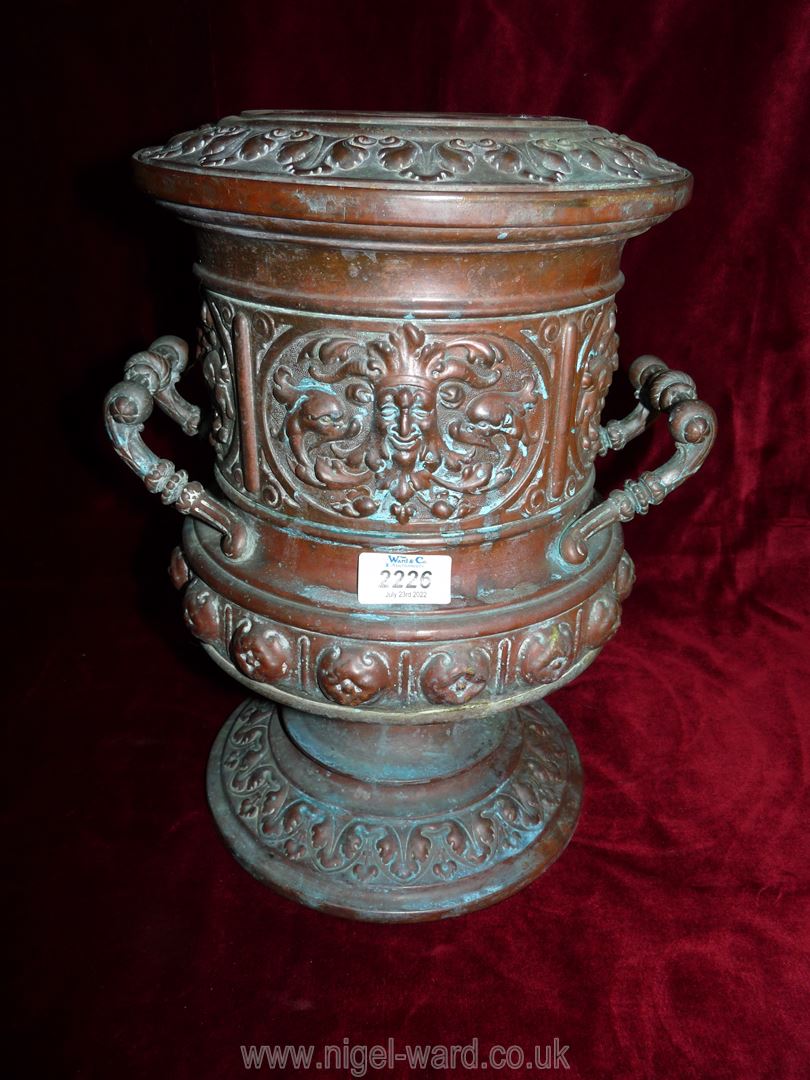 A two handled urn style vase with embossed mask head detail etc.