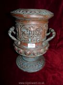 A two handled urn style vase with embossed mask head detail etc.