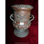 A two handled urn style vase with embossed mask head detail etc.