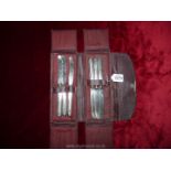 A set of six silver handled butter knives in red leatherette travelling pouch by Cooper Bros & Sons