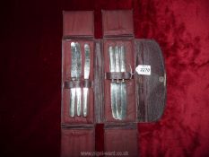 A set of six silver handled butter knives in red leatherette travelling pouch by Cooper Bros & Sons