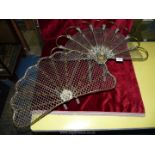 Two brass and mesh fan shaped fire fronts, one with berry and leaf detail,
