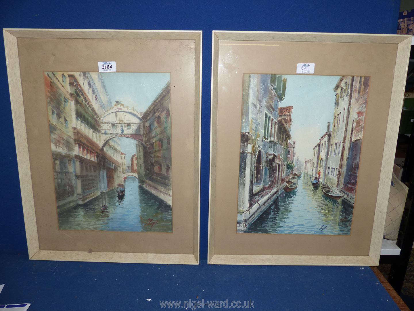 A pair of Venetian Watercolours in white frames, indistinctly signed lower right.