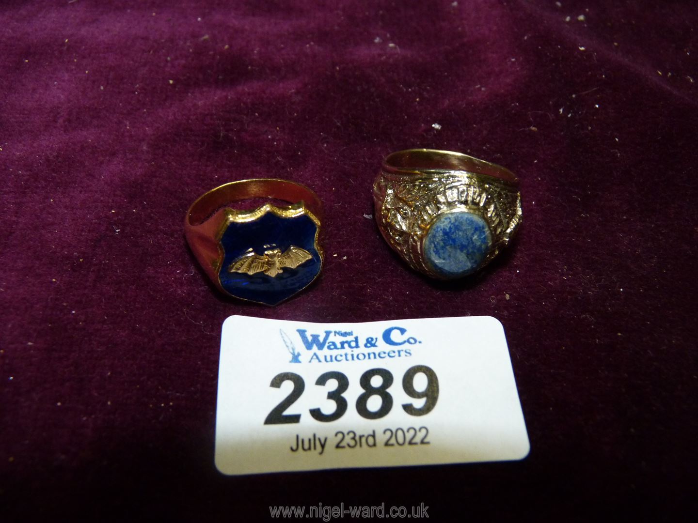 Two unmarked gents rings, one with enamelled shield and bat detail,