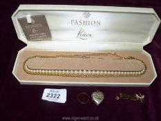 A selection of jewellery including a rose gold 375/9ct wedding ring, a boxed simulated pearl