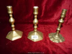 A pair of brass candlesticks with hexagonal bases 7" tall and another with fluted base 6¾" tall.