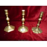 A pair of brass candlesticks with hexagonal bases 7" tall and another with fluted base 6¾" tall.