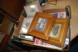 A box of books and picture frames.