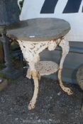 A cast iron table base with stone top, (rim of table base a/f).