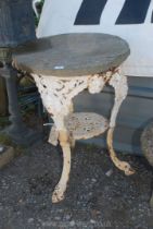 A cast iron table base with stone top, (rim of table base a/f).