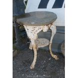 A cast iron table base with stone top, (rim of table base a/f).