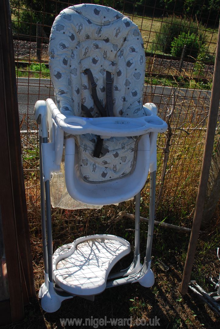 A large folding plastic high chair.