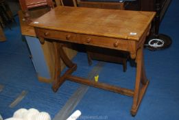 A two drawer oak folk style side table with acorn detail.