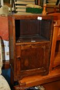 An oak bedside cabinet with cupboard.