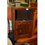 An oak bedside cabinet with cupboard.