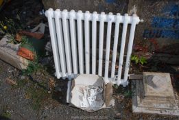 A white metal radiator and brackets 25" x 25".