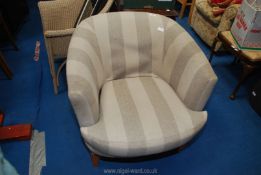 A beige upholstered bucket chair.