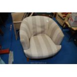 A beige upholstered bucket chair.