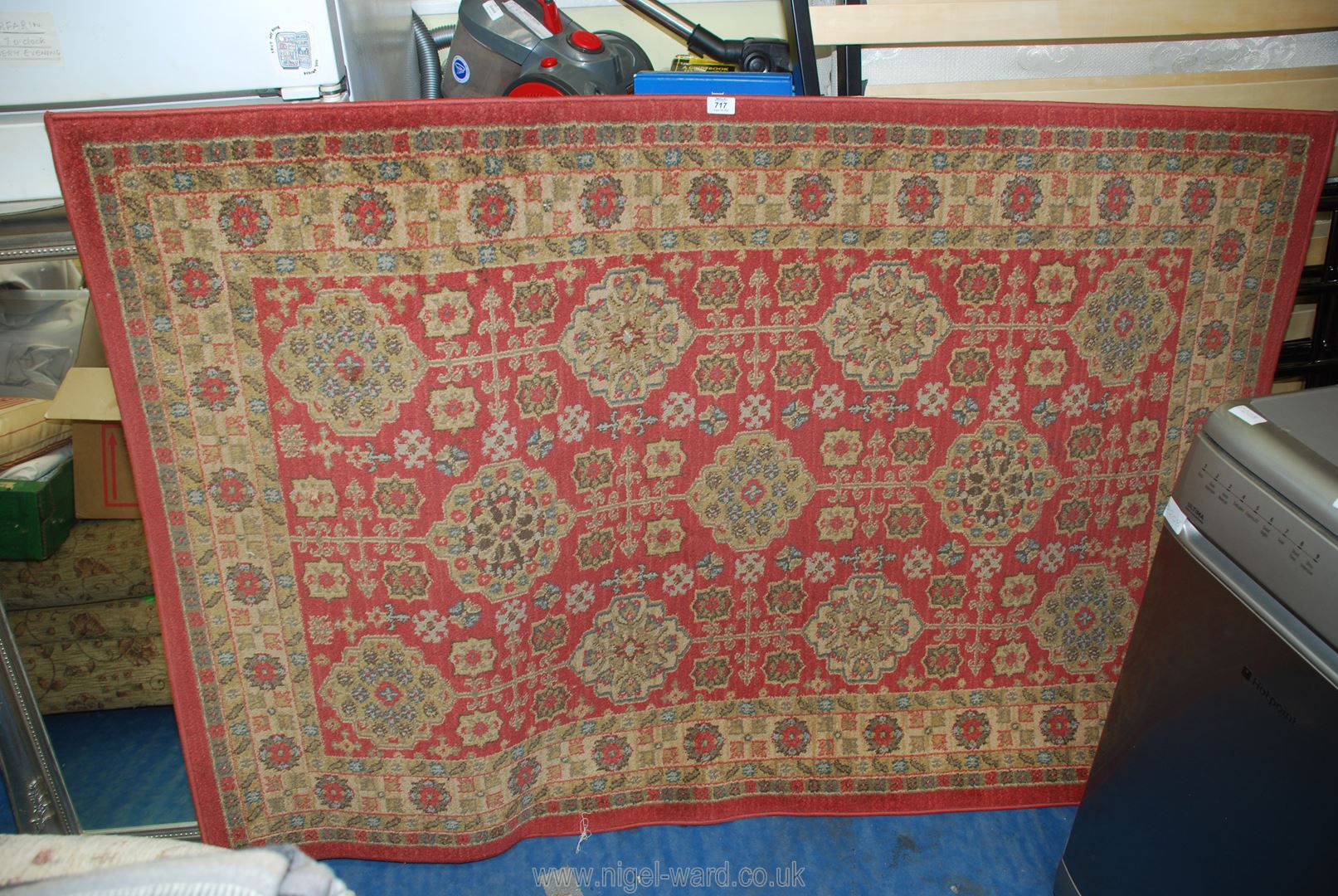 A terracotta ground bordered and patterned rug, 45" x 69".