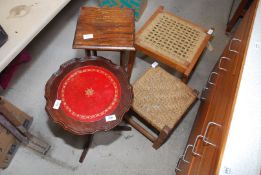 A small round occasional table, plant stand and stools.