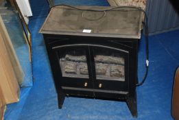 An electric log effect stove/heater, a/f.