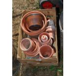 A wooden crate of old terracotta pots.