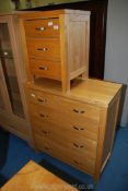 A light Oak/Ash three drawer bedside cabinet and a matching chest of drawers.