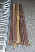 Nine treated triangular edged pieces of timber, 116" long.