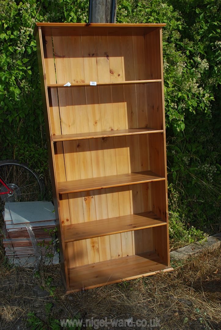 A four shelf standing bookcase, 29" wide x 54" high x 11" deep.