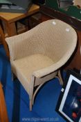 A Lloyd loom wicker chair.