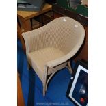 A Lloyd loom wicker chair.