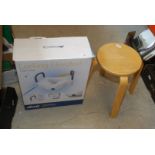 A boxed elevated toilet seat and a small stool.