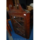 A Mahogany glazed corner cupboard.