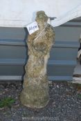 A concrete figure of a woman with dove, 34" tall.