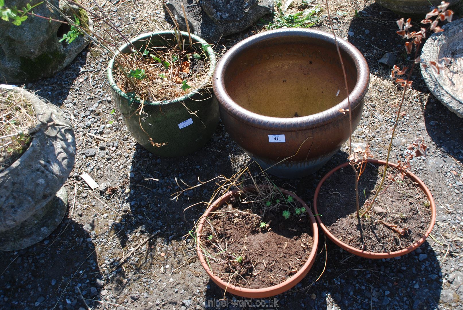 Two glazed planters, green 11" tall, brown 12" tall x 15" diameter and two terracotta bulb pots.