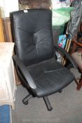 A large leather effect office chair.