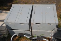 Four grey wooden meter boxes.