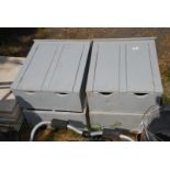 Four grey wooden meter boxes.