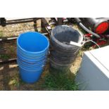 Nine blue calf plastic buckets and ten black plastic buckets.