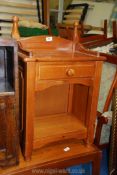 A pine bedside cabinet with drawer.