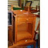 A pine bedside cabinet with drawer.