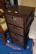 A wood and baskets four drawer unit.