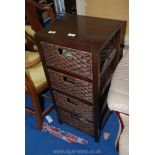 A wood and baskets four drawer unit.