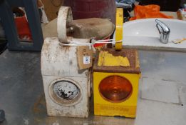 Two vintage metal railway lamps, one white, one orange.