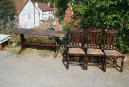 Six oak framed dining chairs and elm topped refectory style dining table, possibly Ercol,