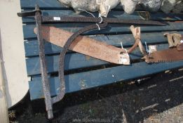 An old hay knife and large iron pot bracket/sway bar.