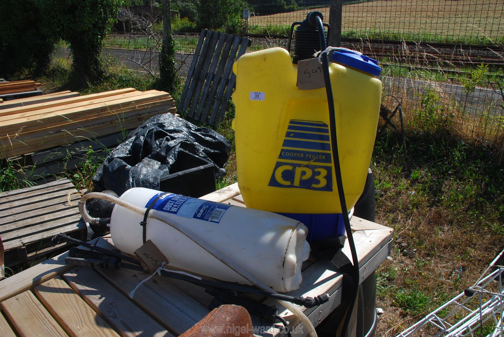 Two garden sprayers, one being a backpack.