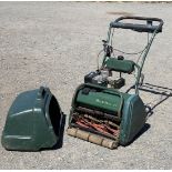 An Atco Balmoral 17s self propelled Petrol Cylinder Lawnmower with grass box and rear roller.