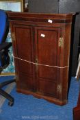 An Oak corner cabinet with Mahogany cross-banding and original brass 'H' hinges 30" x 15" x 40".