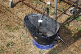 A black painted metal coal scuttle.